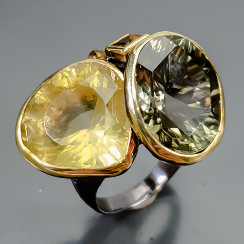 Δαχτυλίδι σε ασήμι 925 με μαύρο και κίτρινο επιχρύσωμα στα 14Κ με μοντέρνο σχεδιασμό και ένα Λέμον Κιτρίνη χαλαζία σε σχήμα pear με If-vvs καθαρότητα στα 19.32 ct , έναν πανέμορφο Πρασιολίτη η πράσινο Αμέθυστο σε fancy oval κοπή με if-vvs  καθαρότητα και βάρος στα 16.97 ct . Το κόσμημα συμπληρώνουν ένας Κιτρίνης Χαλαζίας σε princess κοπή και βαρος 0.80 ct και δύο Κίτρινες Τουρμαλίνες (Μπουεργερίτης) σε κοπή round cab με transparent διαφάνεια και βάρος 0.80 ct . Η προέλευση των λίθων είναι απο την Βραζιλία και την Αφρική.